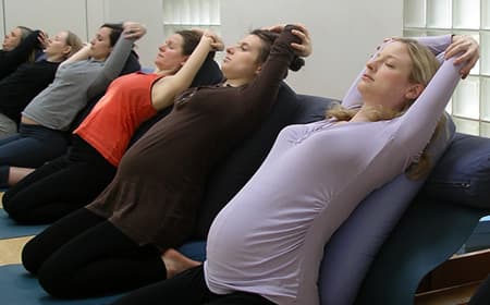 Pregnant woman in Iyengar yoga pose