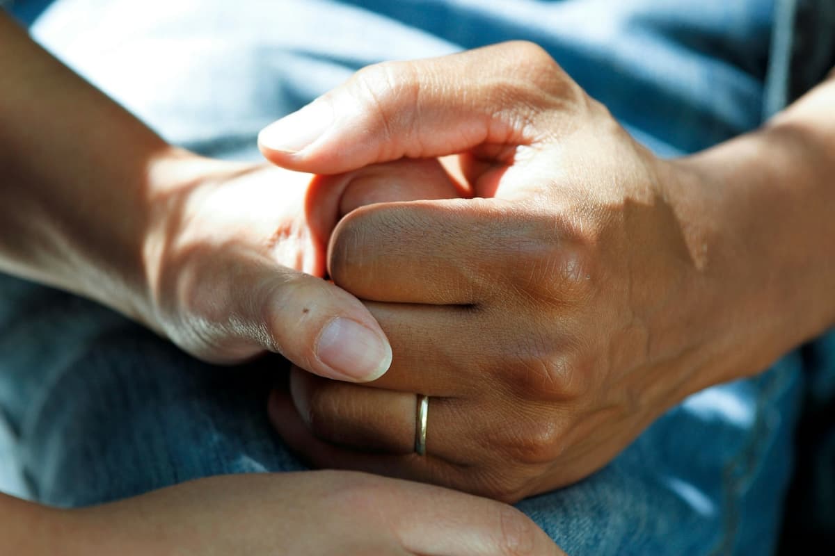 Two hands intertwined, calm and steady